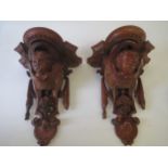 Pair mahogany wall brackets with carved cherub faces and floral decoration 36x25 Condition: In