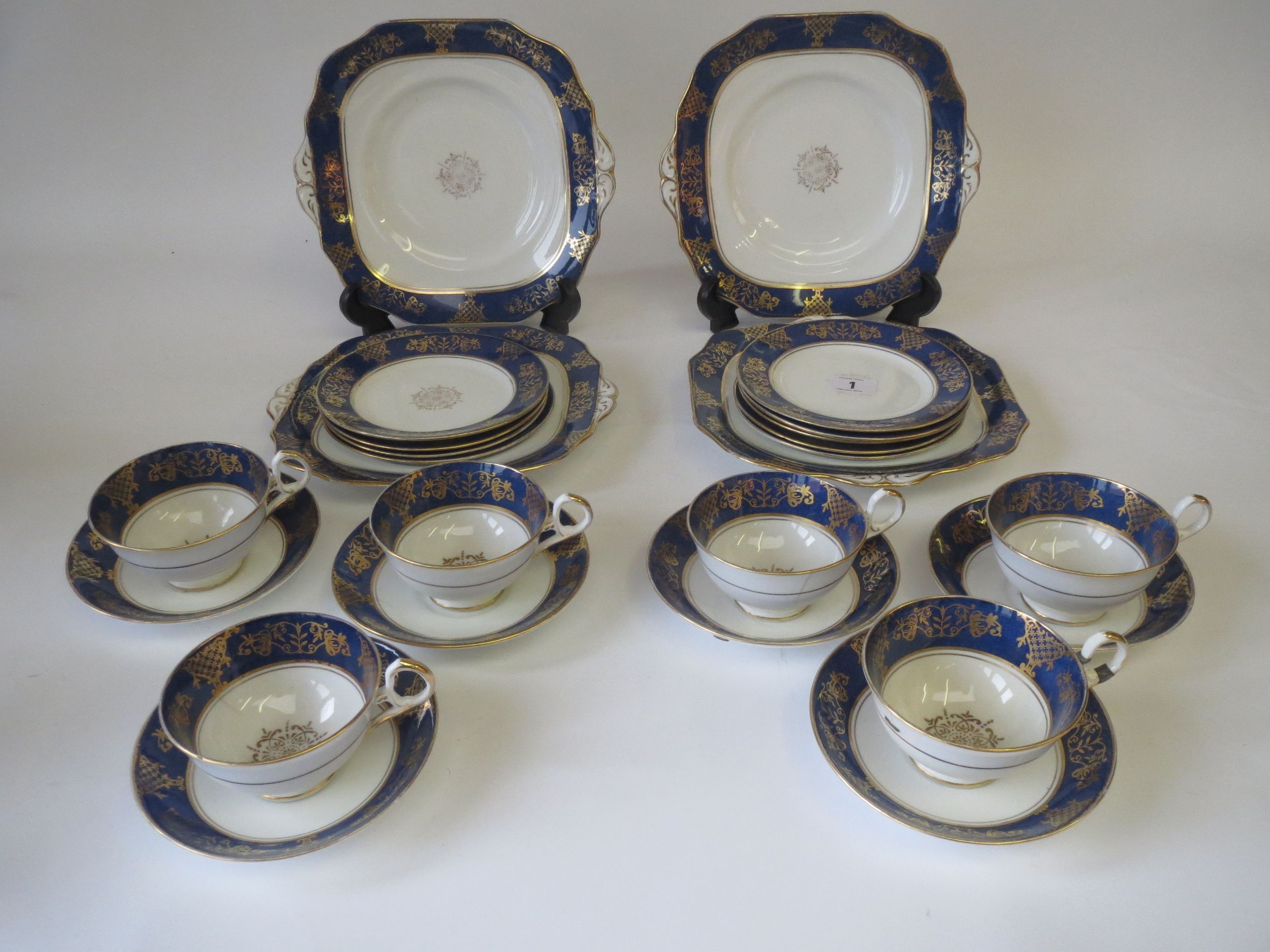 C20th part tea service six cups, six saucers, nine teaplates, three sandwich plates decorated gilt