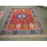 Large South American rug with orange background and blue border with multicoloured geometric pattern