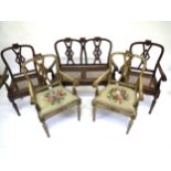 An early C19th part suite of painted Continental walnut framed furniture, the crest rails each