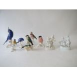 Six continental bird figures by Karl Ens and a pair of figures in the white of courting couples