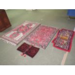 Turkish rug with geometric decoration in red and dark blue to a multi coloured border 190 x 128