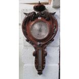 Edwardian carved oak barometer,  86 cm H x 40 cm W Condition: Glass cracked to the dial