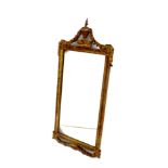 Regency gilt framed oblong wall mirror with vase and swag finial the plate 64 cm x 33 cm Prov: