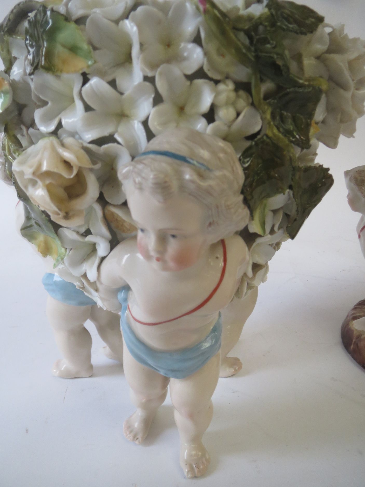 Continental encrusted floral porcelain cherub, a trio vase and a similar oil lamp Condition: very - Image 2 of 2