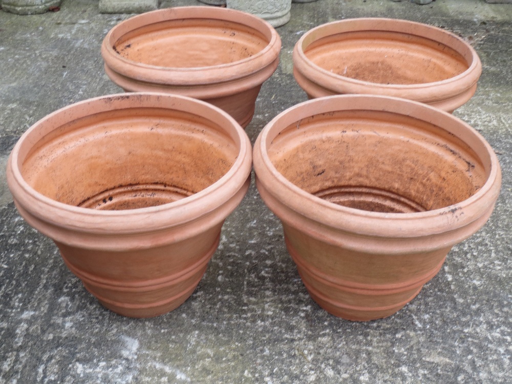 Four garden circular tuns, terracotta colour weathered