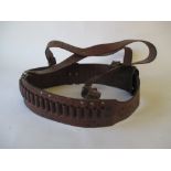 Leather cartridge harness with R.H.A. stamped to the leather. Fair condition