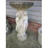 Weathered stone bird bath, the base depicting the "Three Graces" Condition: weathered