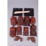 Group of Oriental assorted objects, comprising: eight wooden masks, a pair of carved wooden