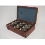 Set of nine white metal stirrup cups in the form of fox masks in fitted wooden case