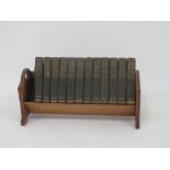 12 volumes of The Every Man Encyclopaedia in wooden book rack