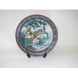 C20th Japanese dish painted in yellow, green blue & brown with figures, mythical dragon & horse,