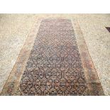 Large rectangular rug with wide stylised geometric border brown, beiges, blues and reds and