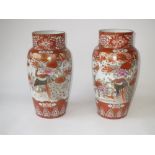 Near matched pair of Japanese Kutani vases in typical palette with birds amidst foliage, tallest