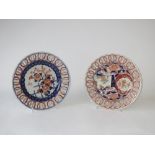 Two Japanese Imari plates each with pierced rims and painted with flowers, 21.5 diameter