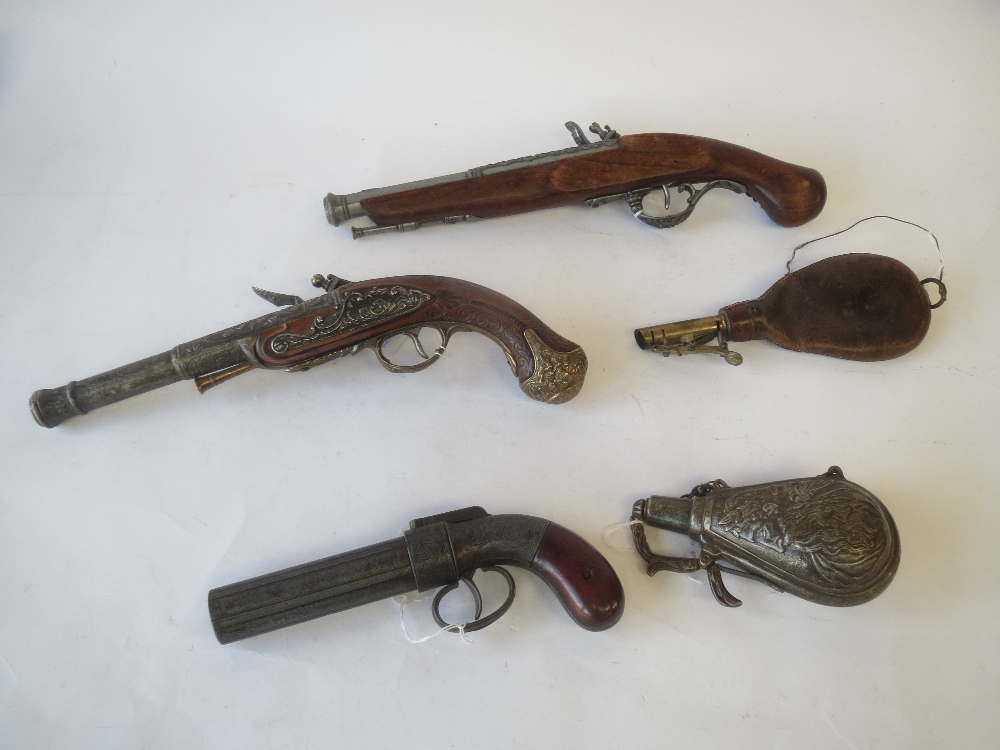 3 reproduction pistol and powder flasks and antique leather and brass powder flas