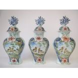 Set of three C19th Continental faience lidded jars decorated with birds and flowers