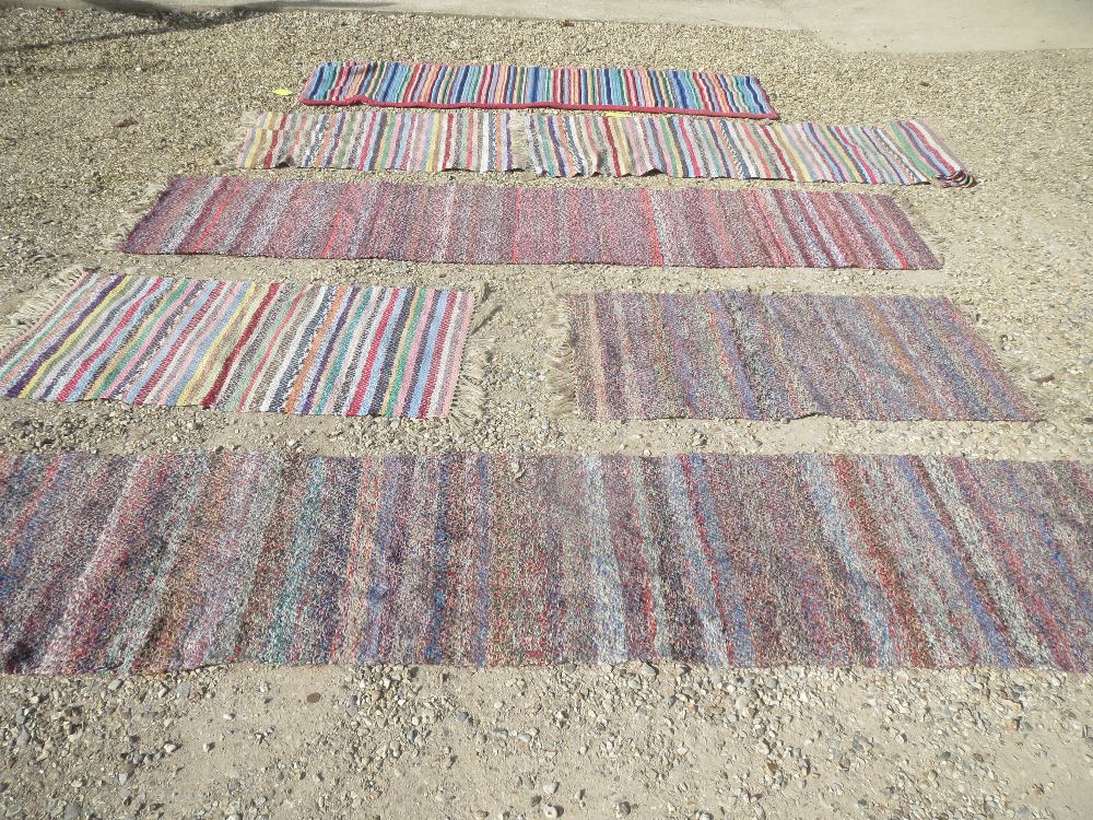 Five assorted hand stitched woollen rugs