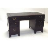 A Chinese ebonised kneehole desk with a bank of two drawers to each pedestal 147 cm wide