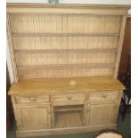 Pine dresser with shelved back over a base with three drawers and two cupboards on plinth base 191cm