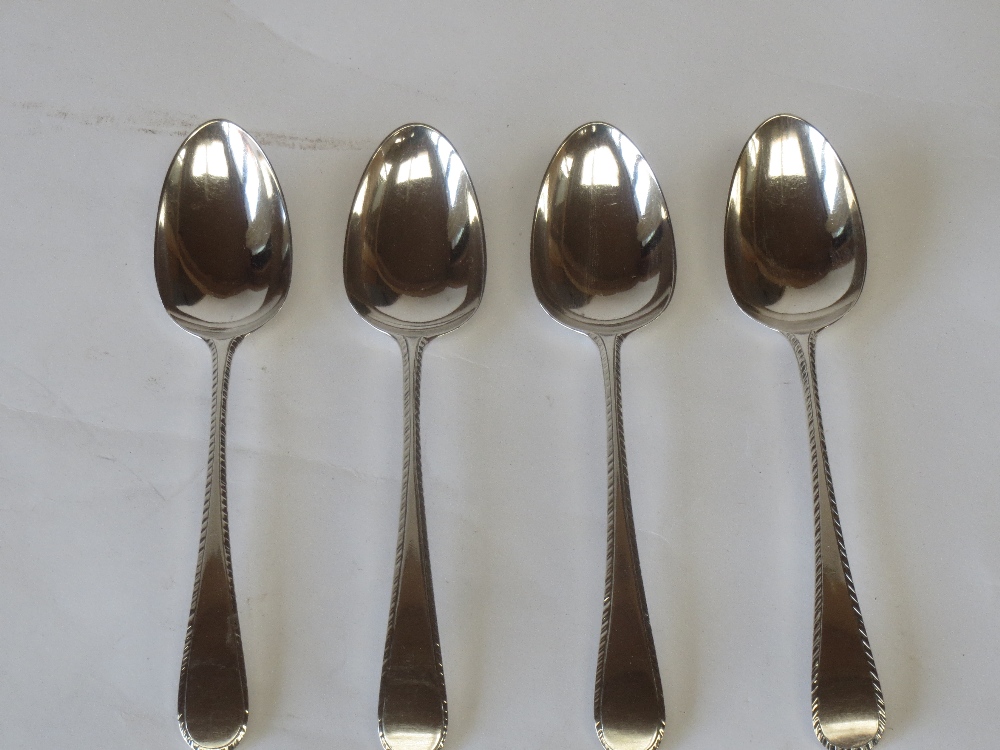 Four mixed hallmarked silver dessert spoons with feathered edged decoration 4ozt