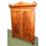 A C19th mahogany and gilt metal moulded linen press in the Empire taste fitted a pair of doors