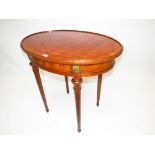 A C19th satinwood oval topped parquetry inlaid occasional table with applied gilt metal mounts on