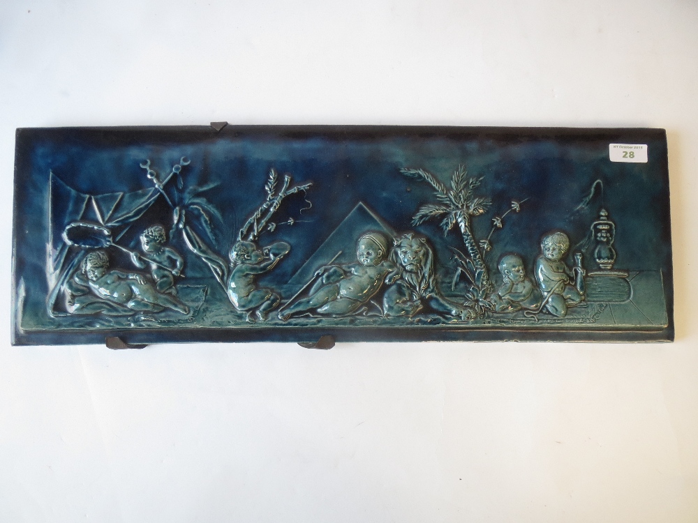 Burmantofts style turquoise/blue glazed pottery plaque depicting cherubs resting in an Egyptian