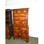 A walnut veneered secretaire tallboy, fitted two short, two long and a secretaire drawer over a base