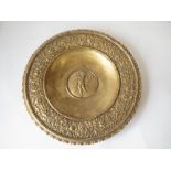 c.1900 Gilt metal circular dish with cherubic and clasical decoration, stamped 'GESETZLICH,