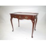 A George III mahogany silver table of shaped serpentine outline over a frieze drawer on cabriole