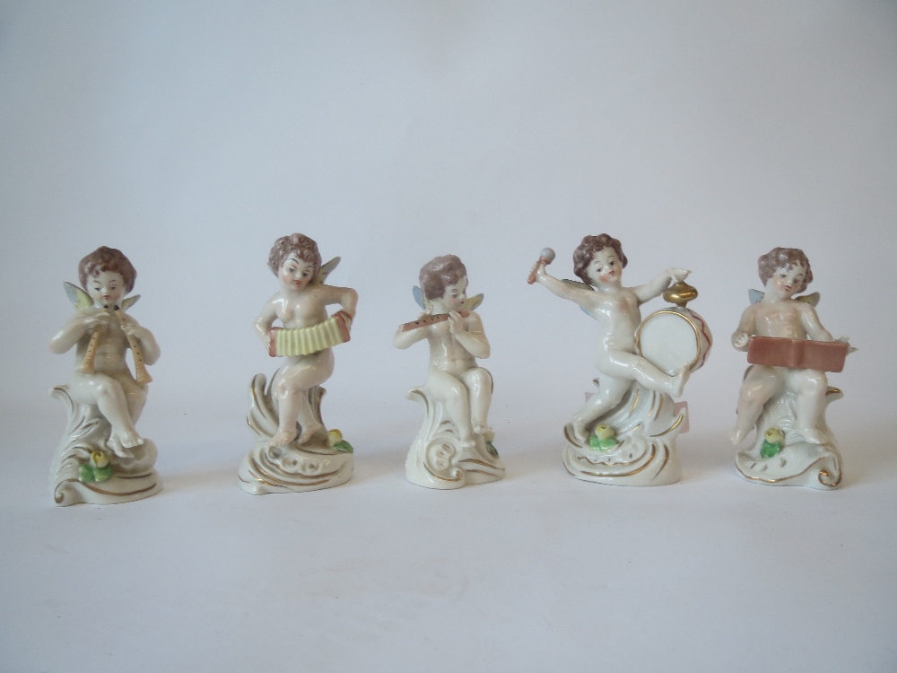 Set of five Neapolitan musical cherub figures 12cm H. 
The cherubs have slight chips for the wings