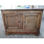 C19th Continental fruitwood sideboard with cleated end top over pair of doors on bracket feet