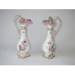 Pair of C19th porcelain ewer shaped oil and vinegar bottles painted with flowers on rococo style