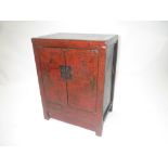 A C19th Chinese red lacquered two door cabinet with gilt decoration 82 cm dia