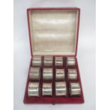 12 mixed Hallmarked silver napkin rings in fitted leather case 12ozt