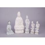 Five Chinese white-glazed porcelain figures of Guanyin, two modelled seated, 26.5cm high max. (5)