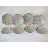 Set of four Japanese tea plates decorated multicoloured chrysanthemums to a black and gilt border