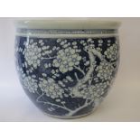 Chinese blue and white fish bowl with overall blue and white prunus blossom decoration, 35cm H crack