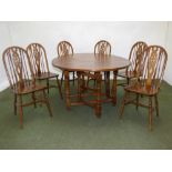 Modern oak gate leg dining table and six beech wheel back chairs and two nests of tables, and gilt