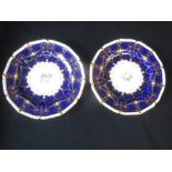 Pair of Royal Crown Derby cabinet plates painted a central floral spray within Cobalt blue and
