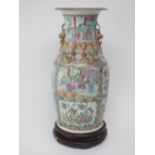 Canton Famille Rose decorated vase depicting panels of domesticity  between panels of flowers,