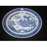 Large C18th Nanking Cargo meat plate, decorated in underglaze blue with buildings, figure on a