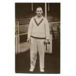 J.B. 'Jack' Hobbs. Sepia real photograph postcard of Hobbs, full length, stood at the pavilion