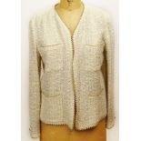 From a Palm Beach Socialite, A Retro Chanel Ivory Colored Boucle Jacket with Faux Pearl Accent Trim.