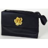 From a Palm Beach Socialite, A Chanel Black Satin Evening Bag. Goldtone Floral Decoration. Black