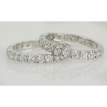 Pair of lady's approx. .75 carat round cut diamond and 14 karat white gold eternity bands. Total