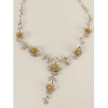 Lady's fine quality 18 karat white and yellow gold flower necklace accented with round cut yellow