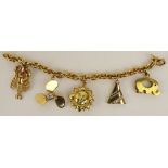 Lady's vintage 18 karat yellow gold charm bracelet with four 14 karat yellow gold charms and one