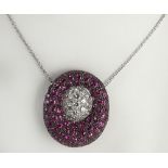 Lady's modern design round cut ruby, diamond and 18 karat white gold pendant necklace. Clasp